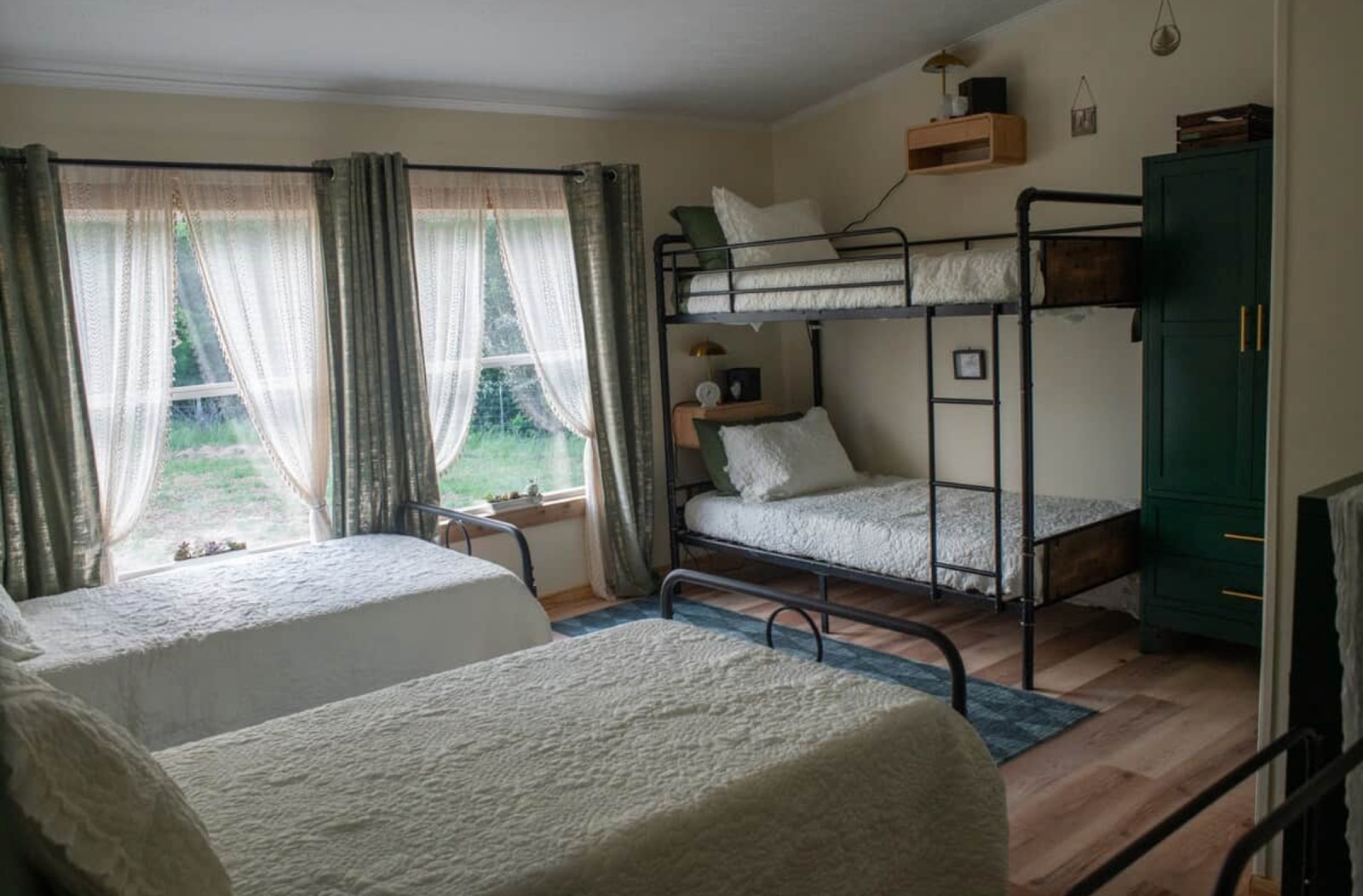 Indoor bunk room with bunk bed and twin beds